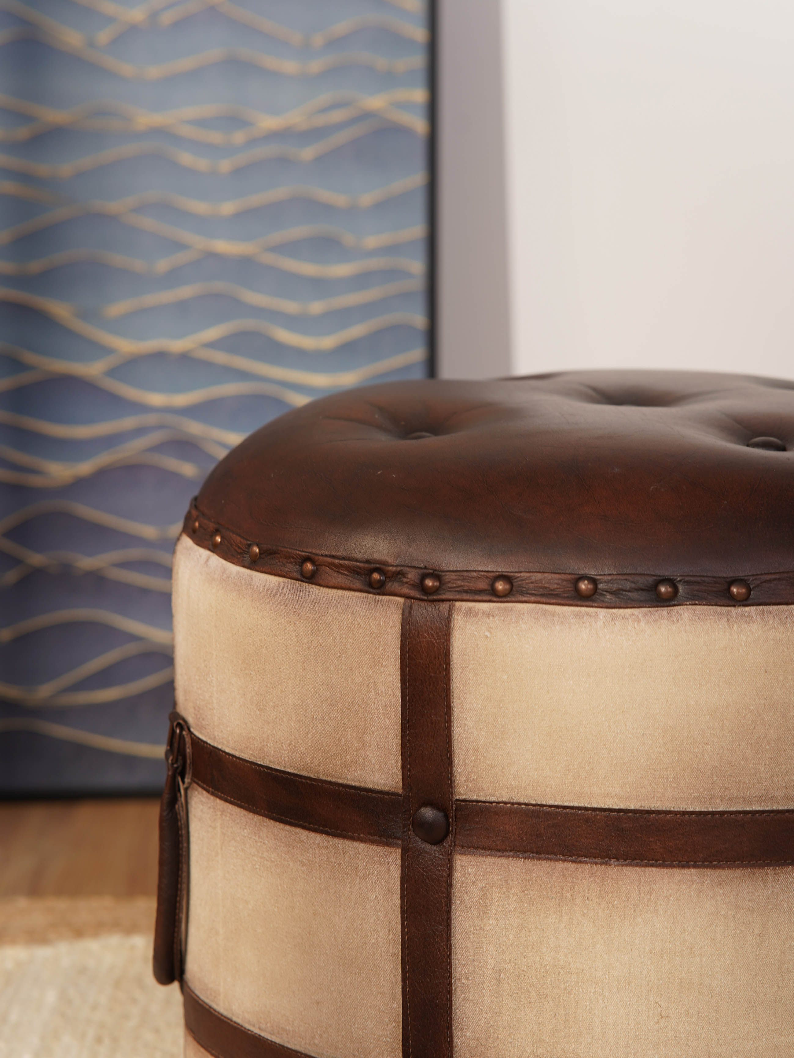 Leather button-tufted top of handcrafted round ottoman