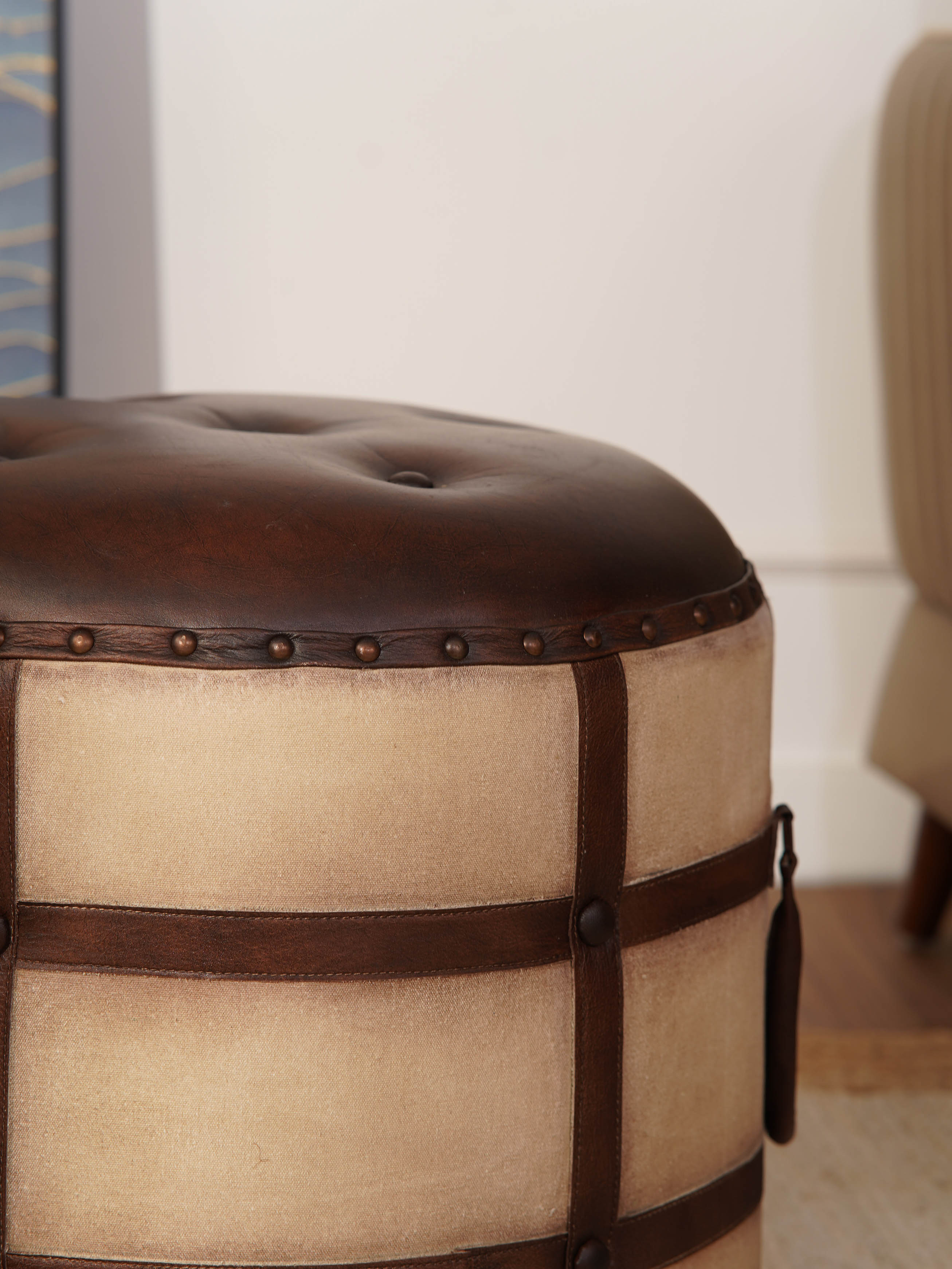 Leather button-tufted top of handcrafted round ottoman