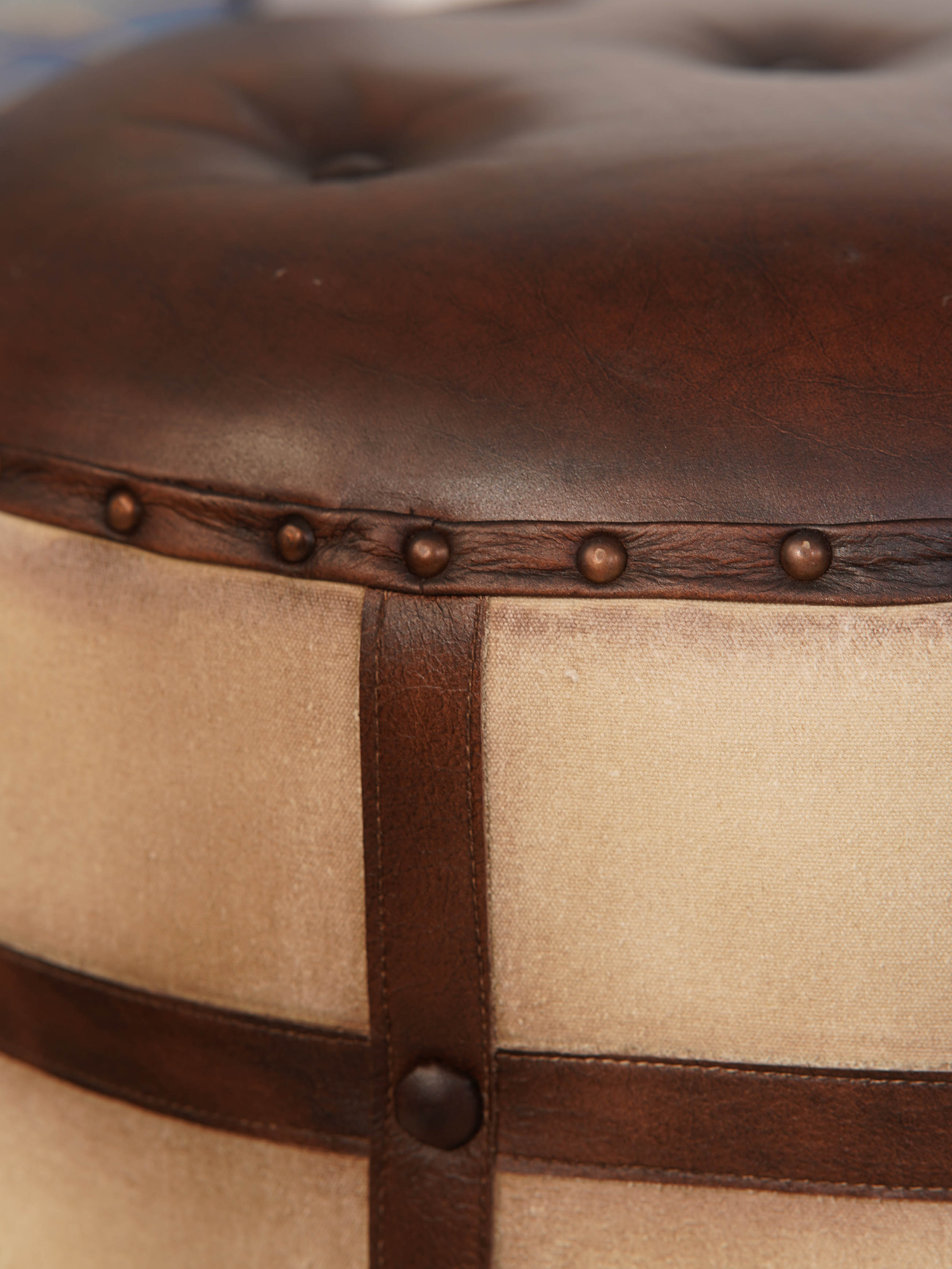 Leather button-tufted top of handcrafted round ottoman