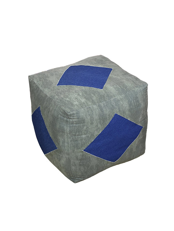 Handmade pouf with blue appliqué diamond shapes on each side