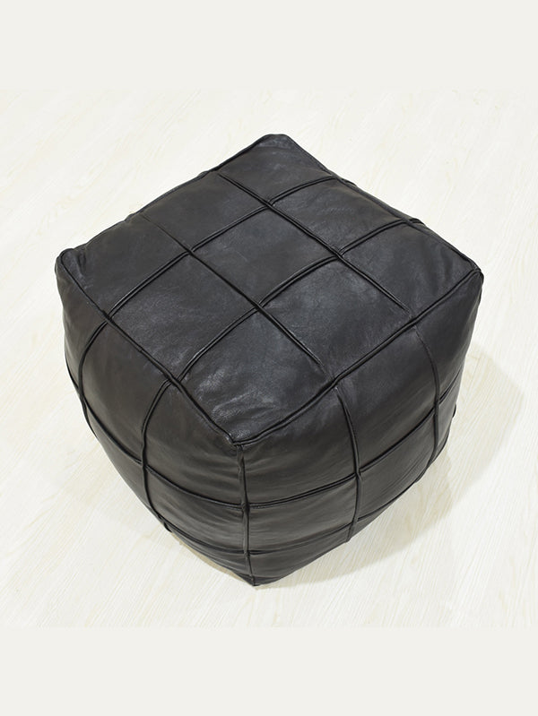 Overhead view of filled square black leather ottoman