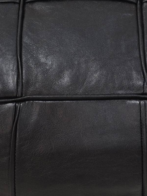 Detail of full grain leather and artisan stitching on black pouf