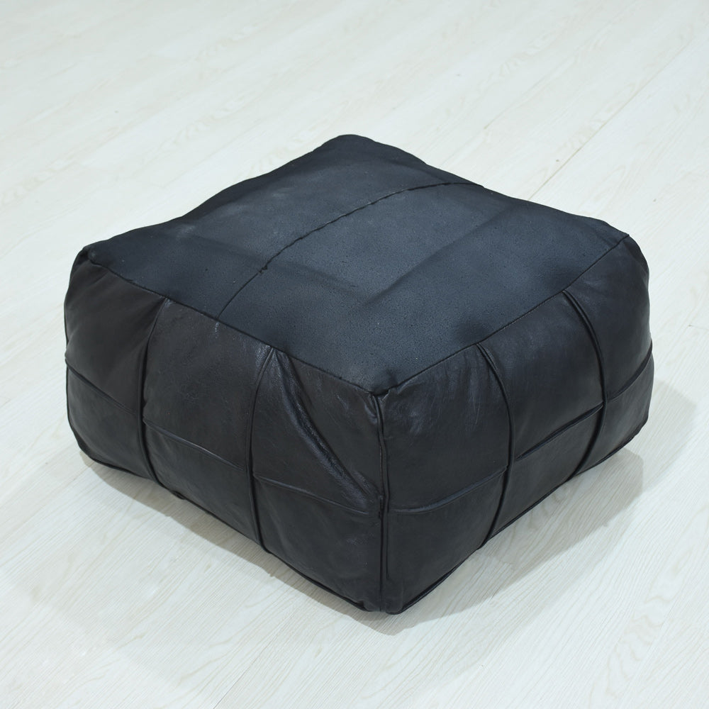 Handmade leather pouf in black with stitched square panels upside down