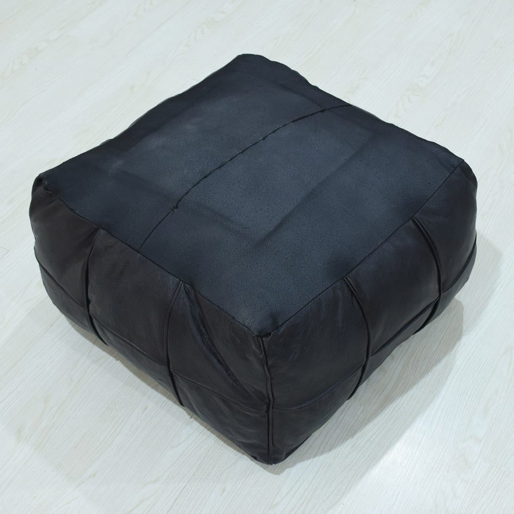 Handmade leather pouf in black with stitched square panels upside down
