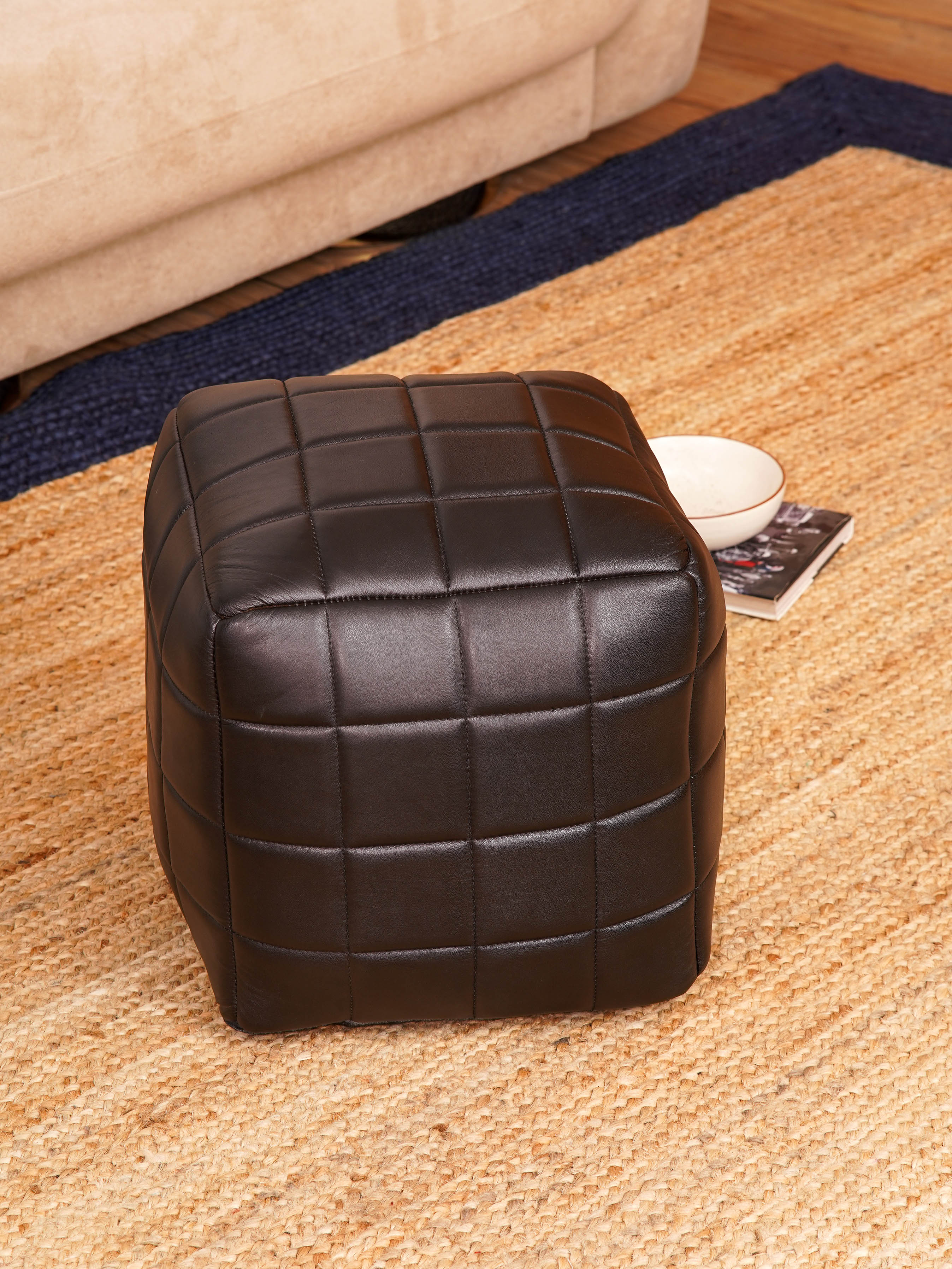 Top-down view of Metro Grid Leather Pouf showing square shape and stitched leather texture