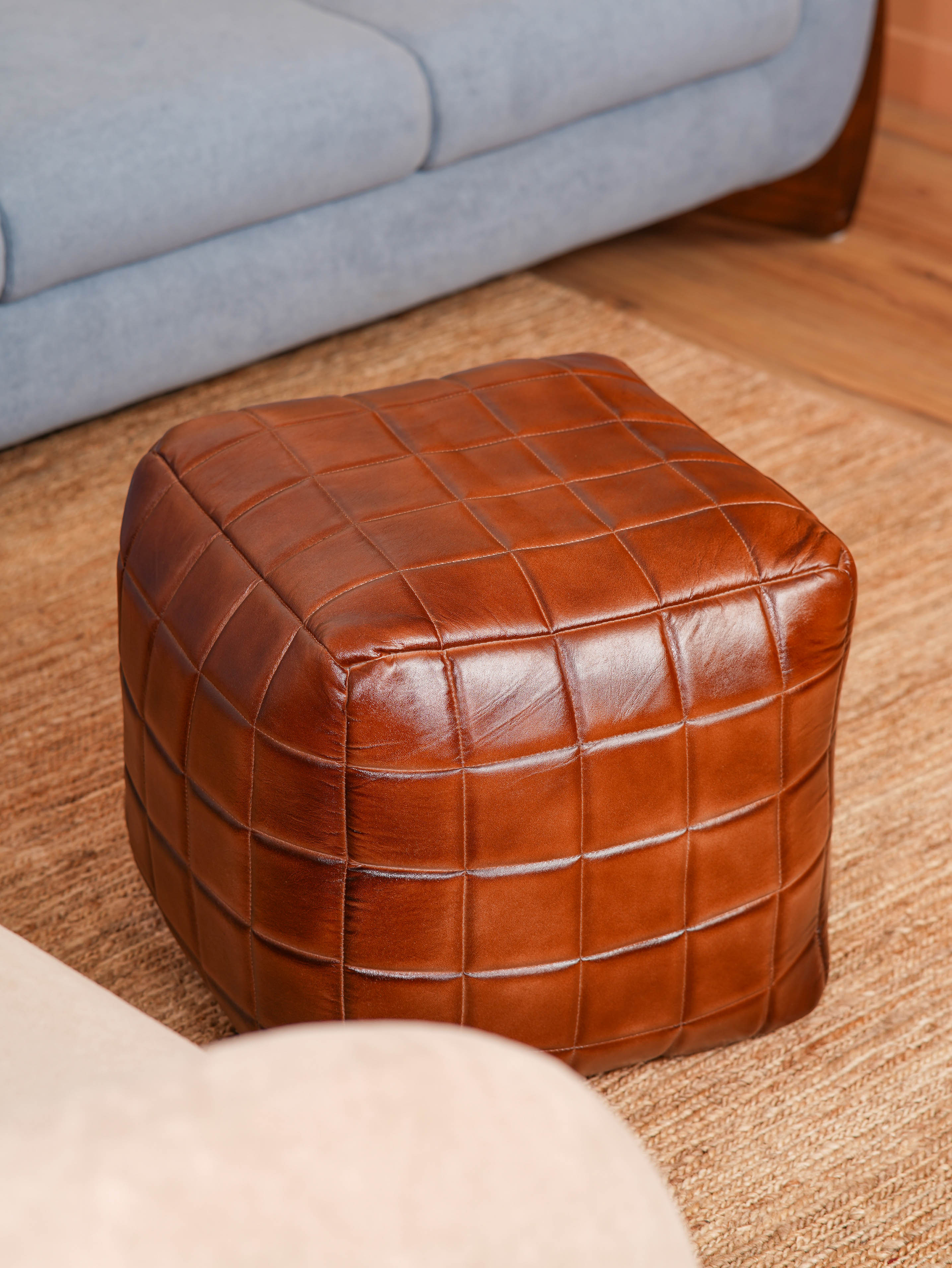 Top-down view of Metro Grid Leather Pouf showing square shape and stitched leather texture