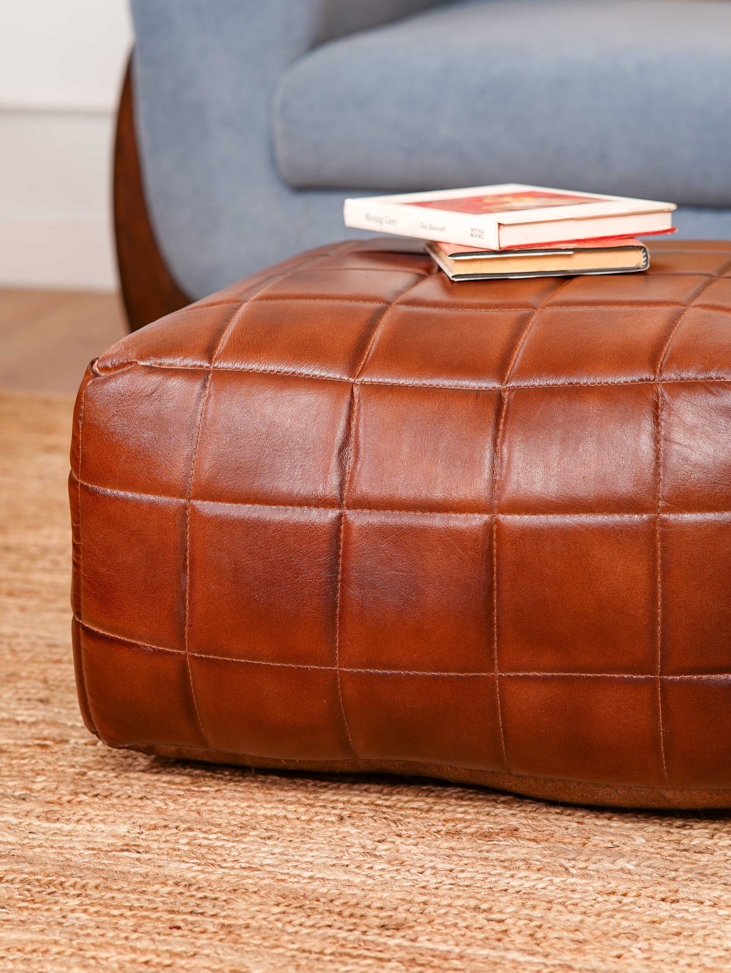 Hand-stitched grid pattern on brown square pouf