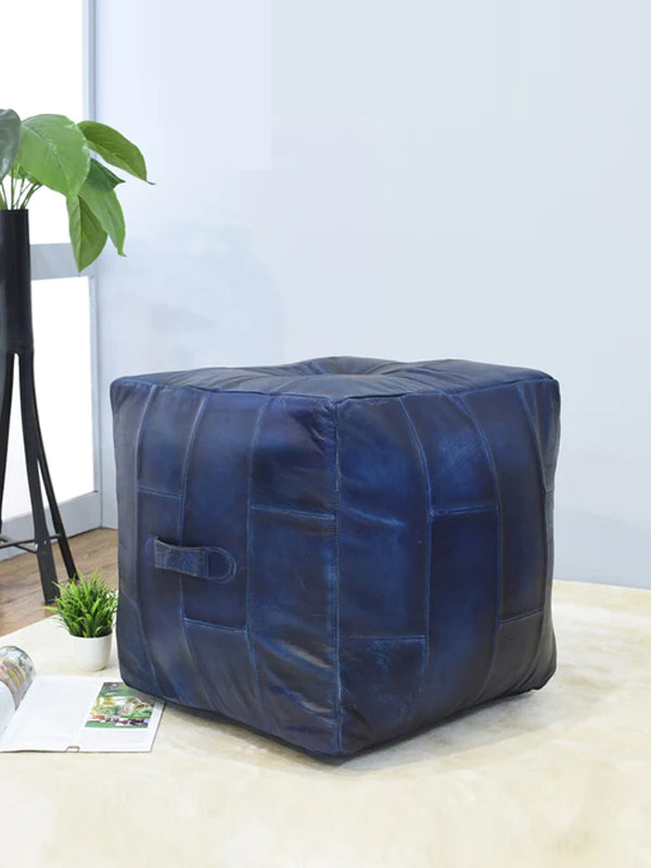 Square blue leather pouf in minimal living room with soft rug