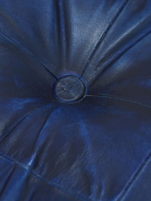 Close-up of vintage blue leather texture with hand-stitched detail