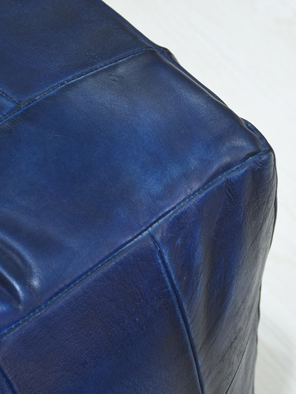 Close-up of vintage blue leather texture with hand-stitched detail