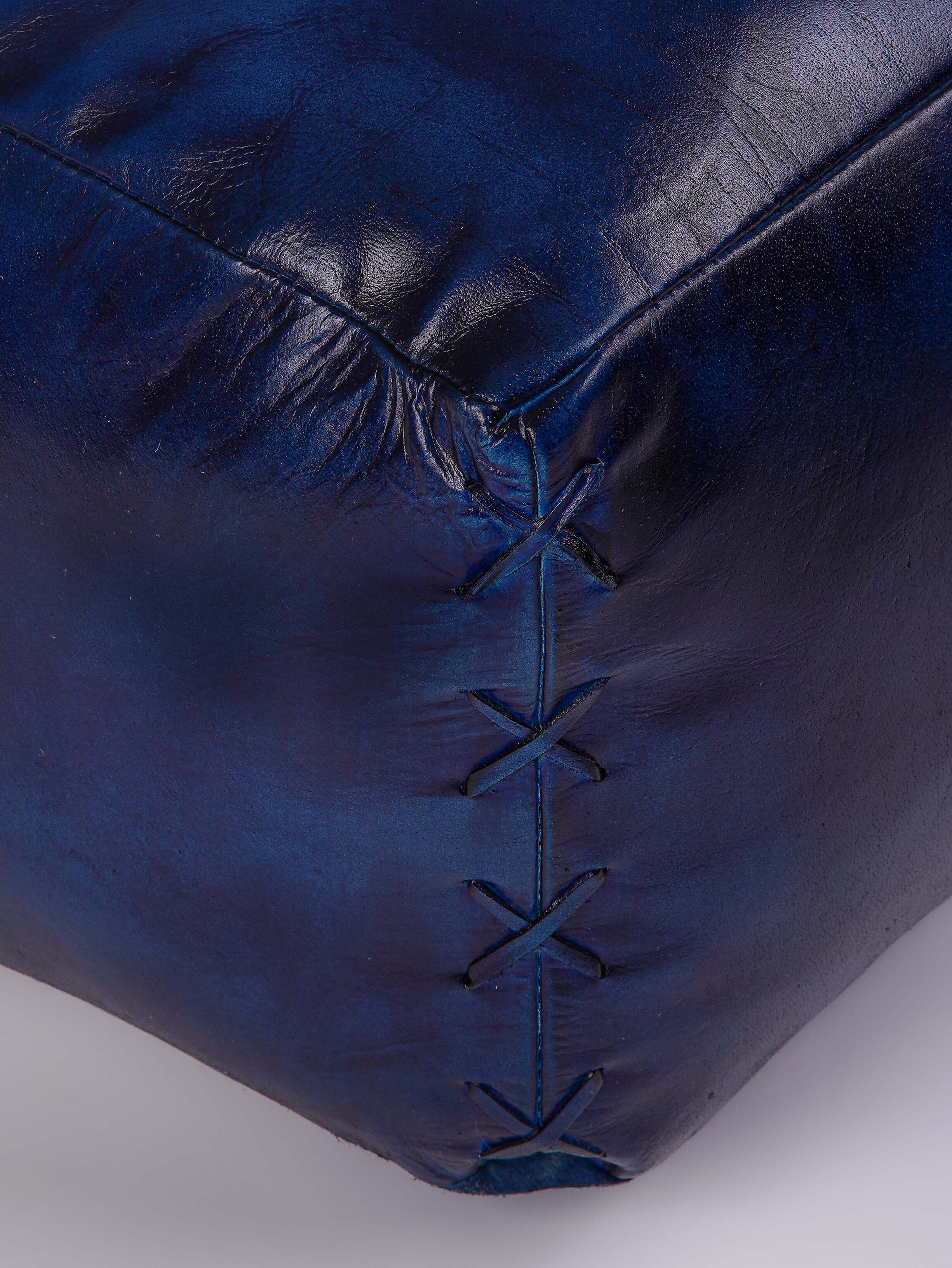 Detail of milled full grain buffalo leather and hand-stitched seams