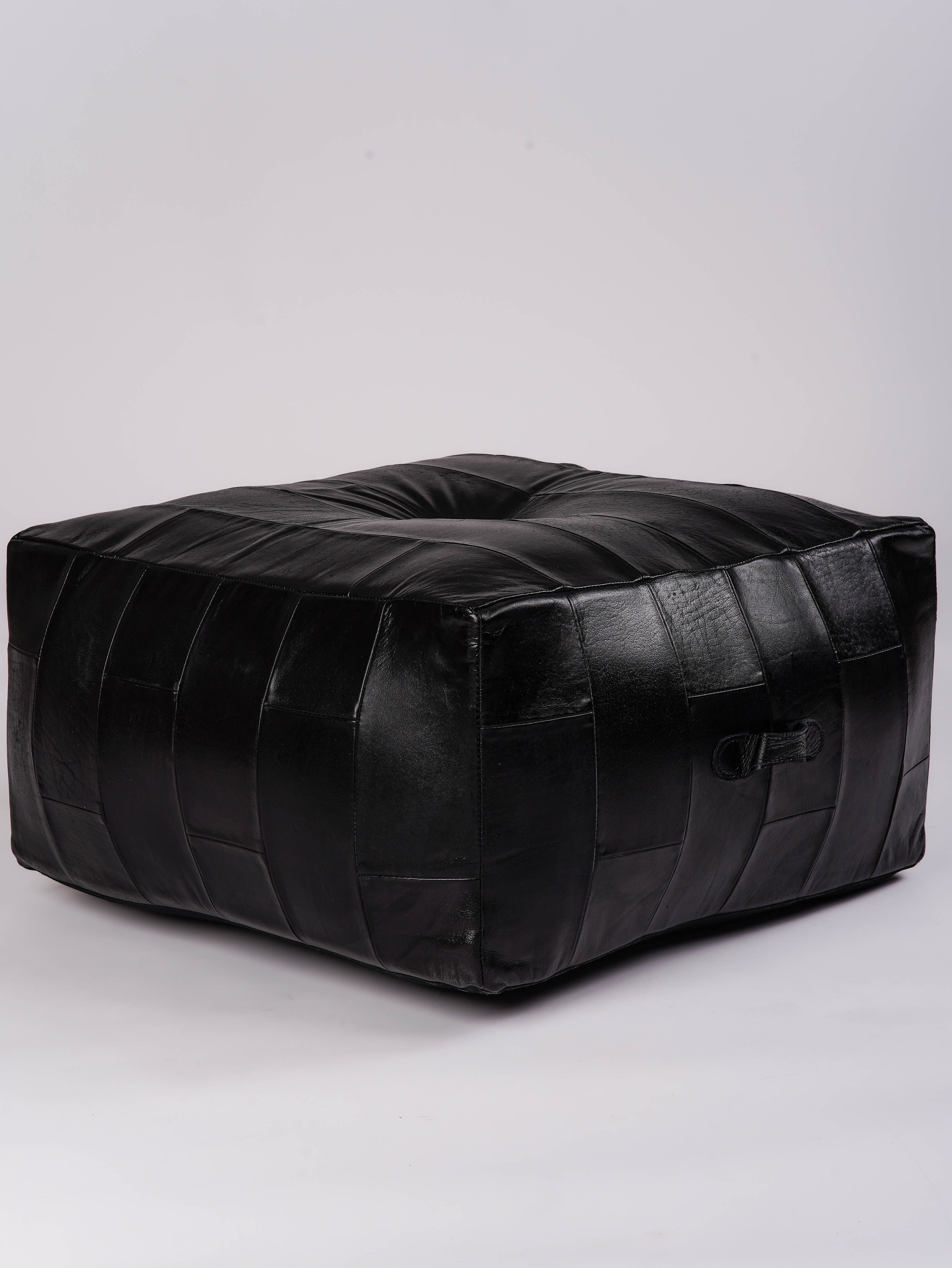 Sleek stitched leather ottoman with vertical panel design