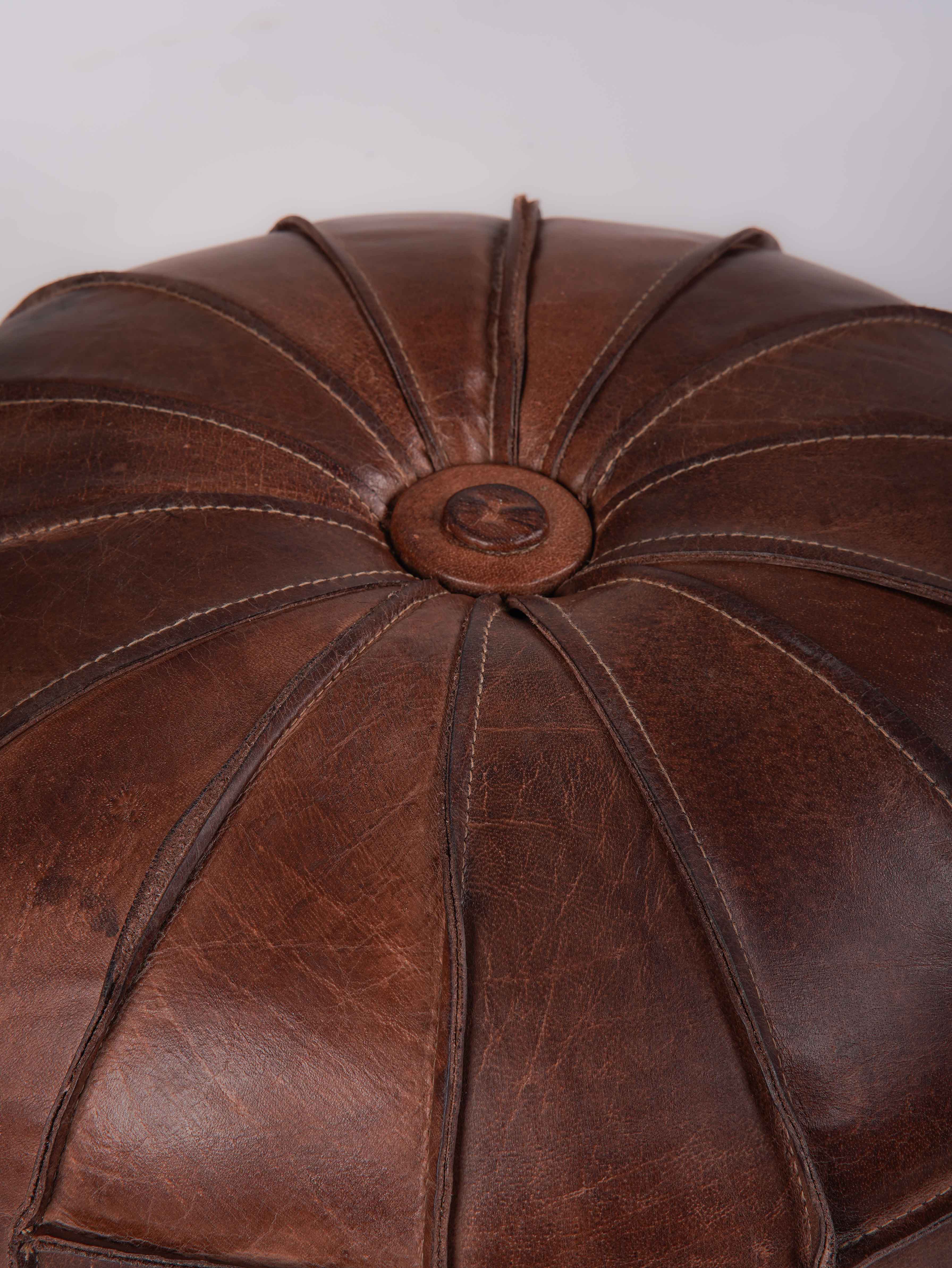 Detail of prairie-style stitching on black buffalo leather pouf