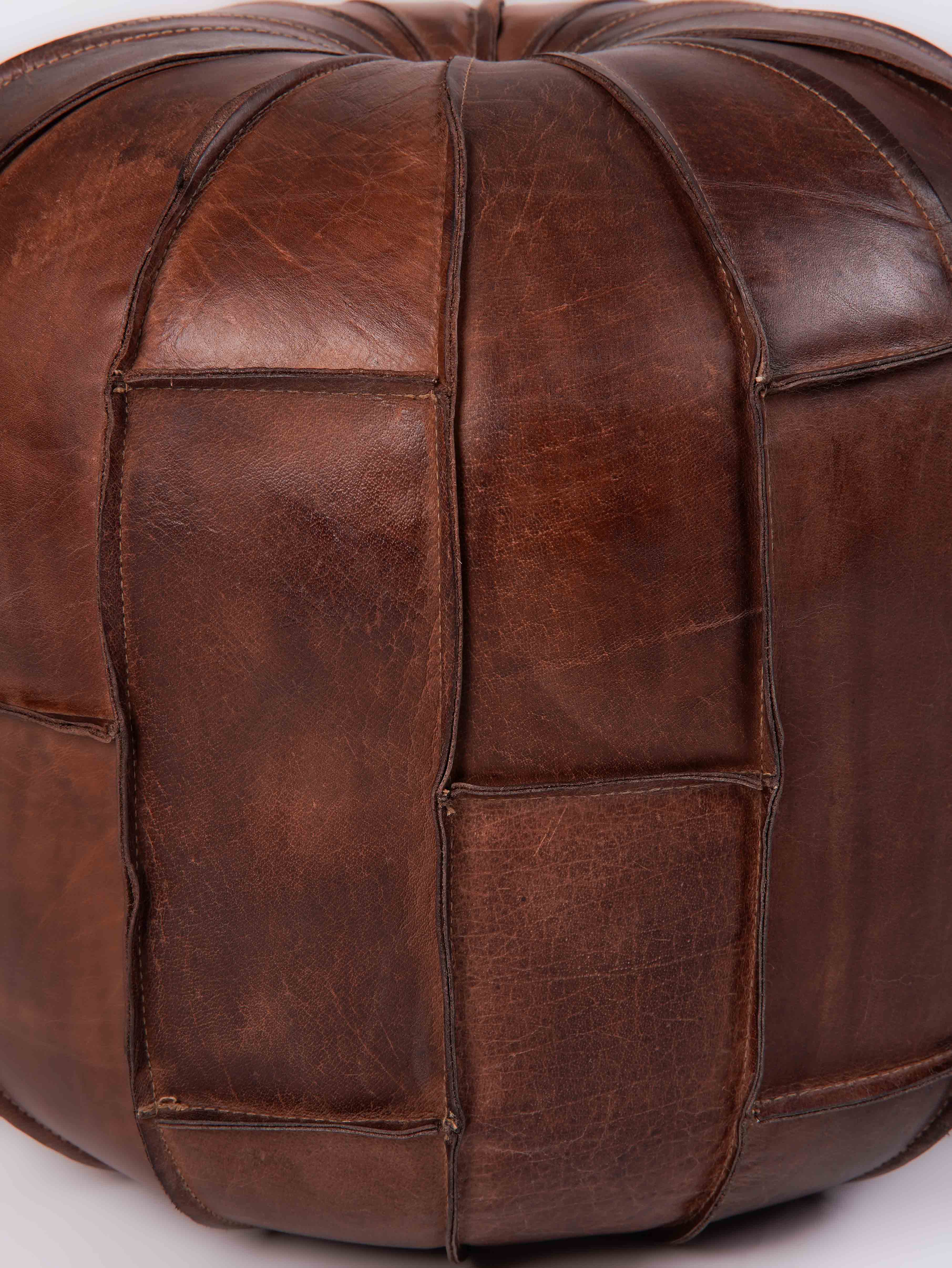 Detail of prairie-style stitching on black buffalo leather pouf