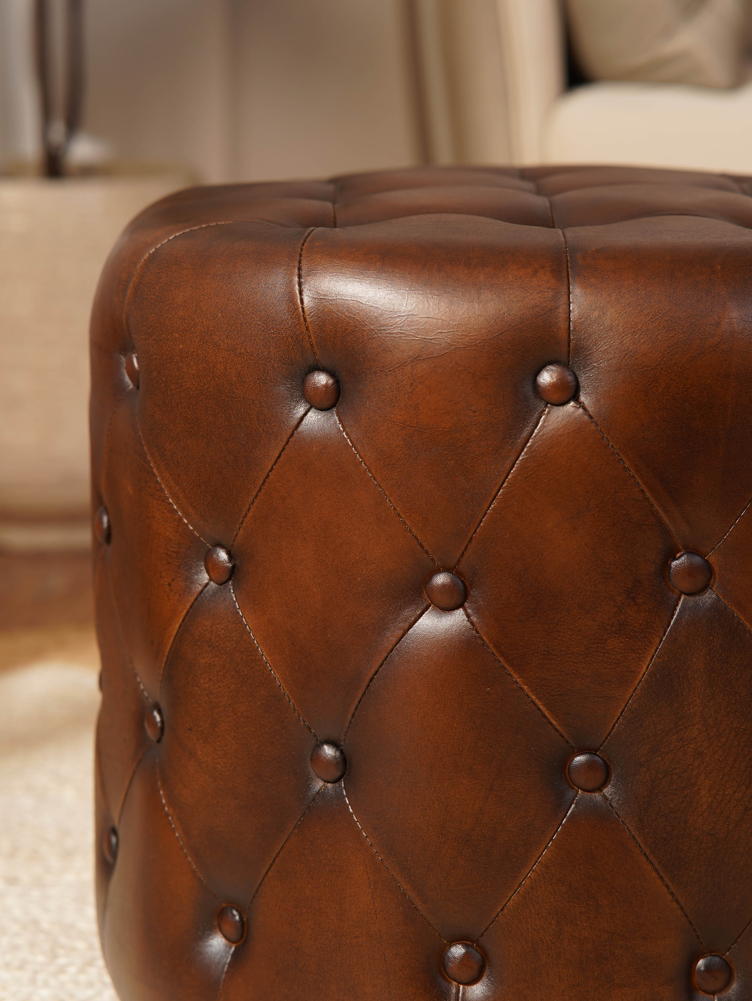 The Regal Repose – Round Tufted Leather Ottoman with Solid Wood Frame