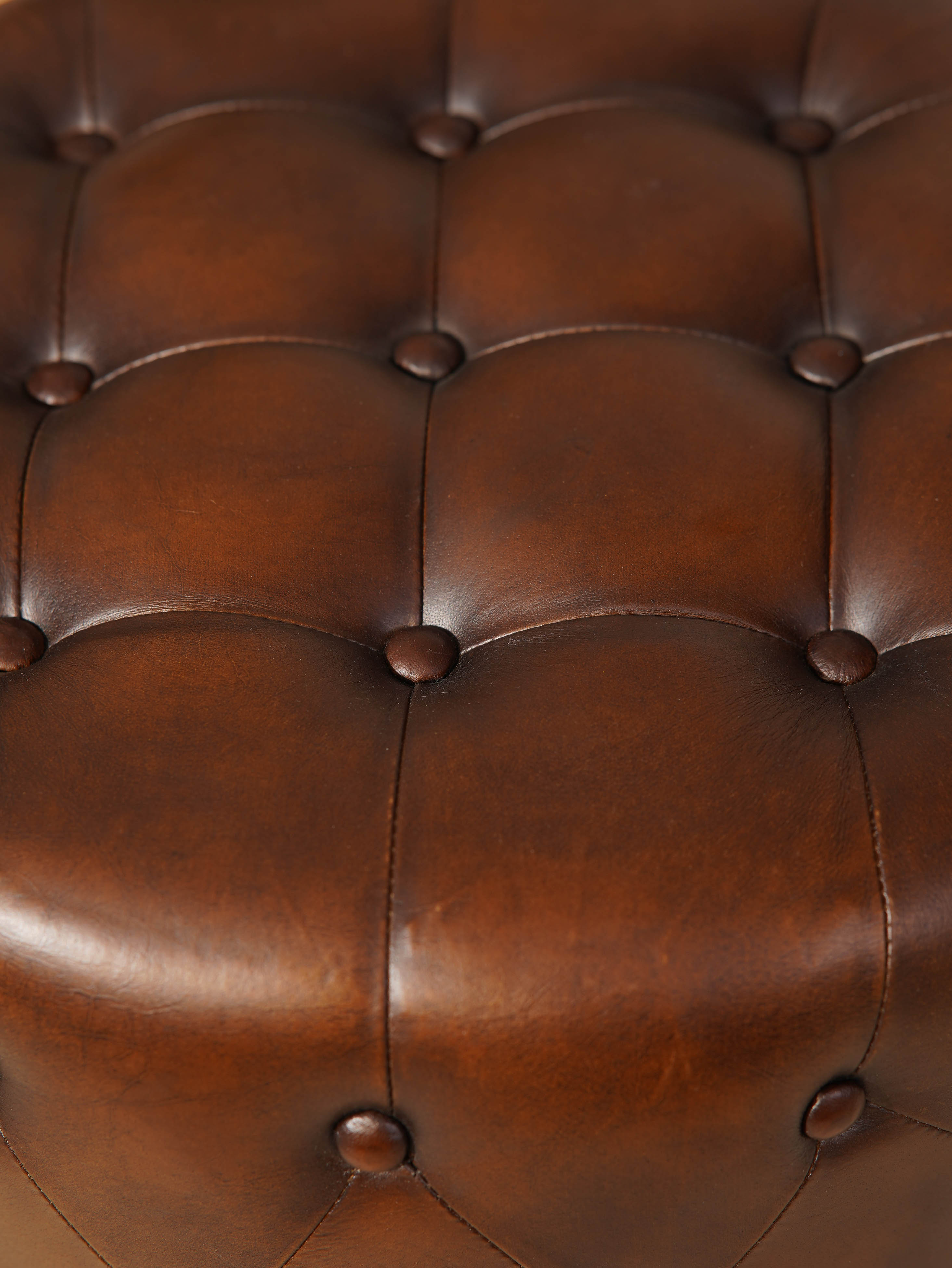 The Regal Repose – Round Tufted Leather Ottoman with Solid Wood Frame