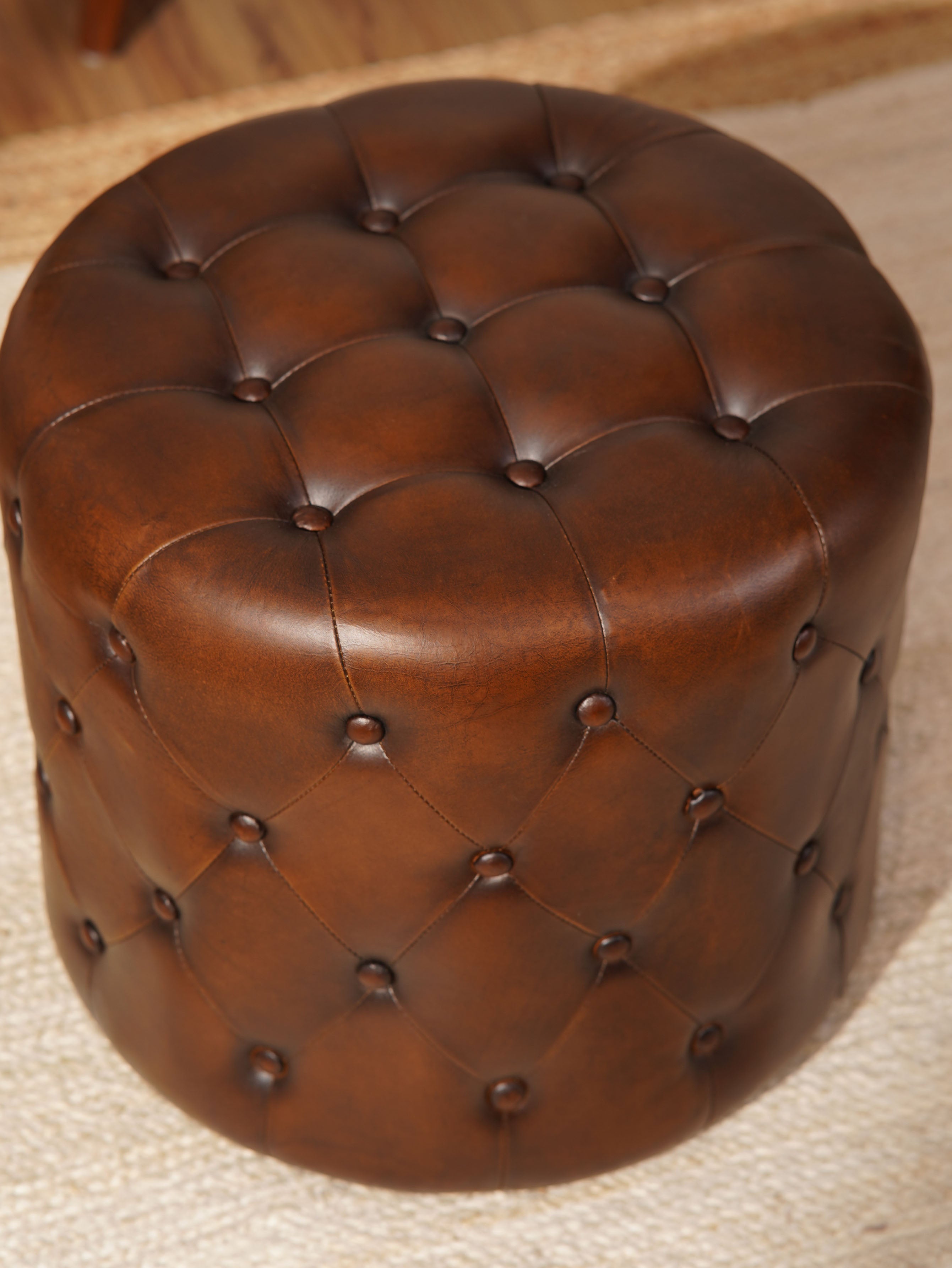 The Regal Repose – Round Tufted Leather Ottoman with Solid Wood Frame