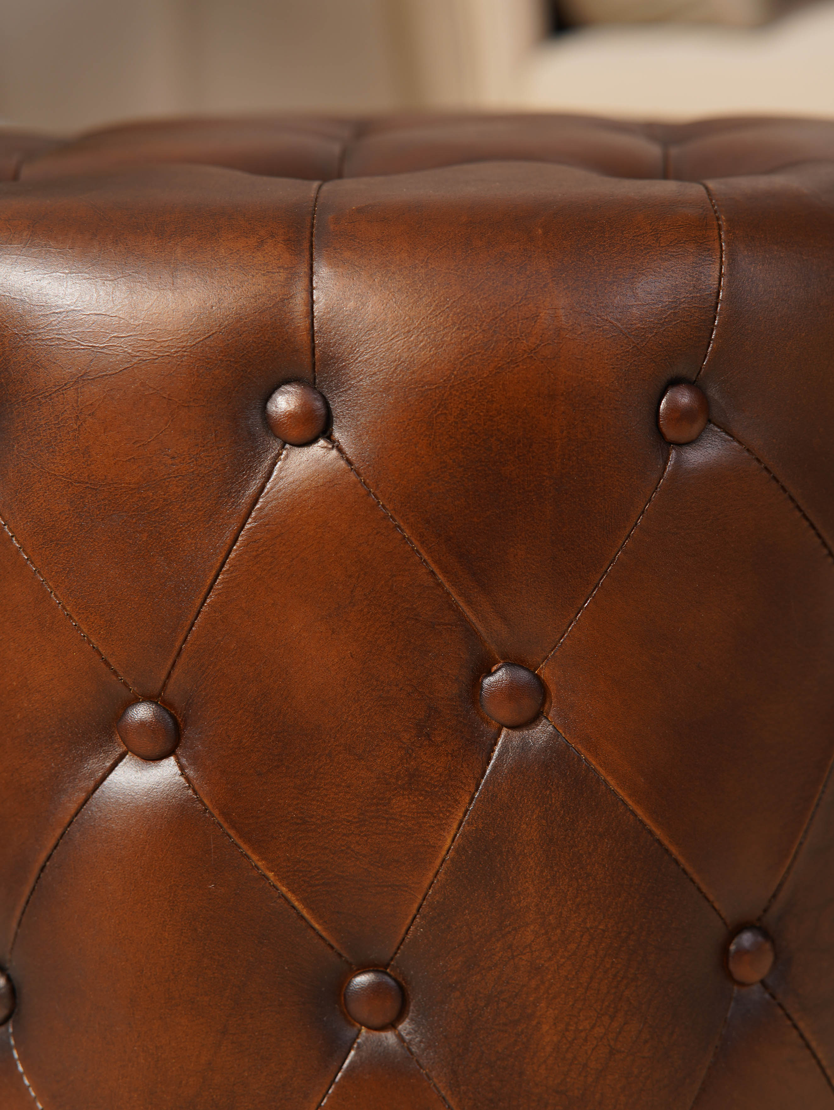The Regal Repose – Round Tufted Leather Ottoman with Solid Wood Frame
