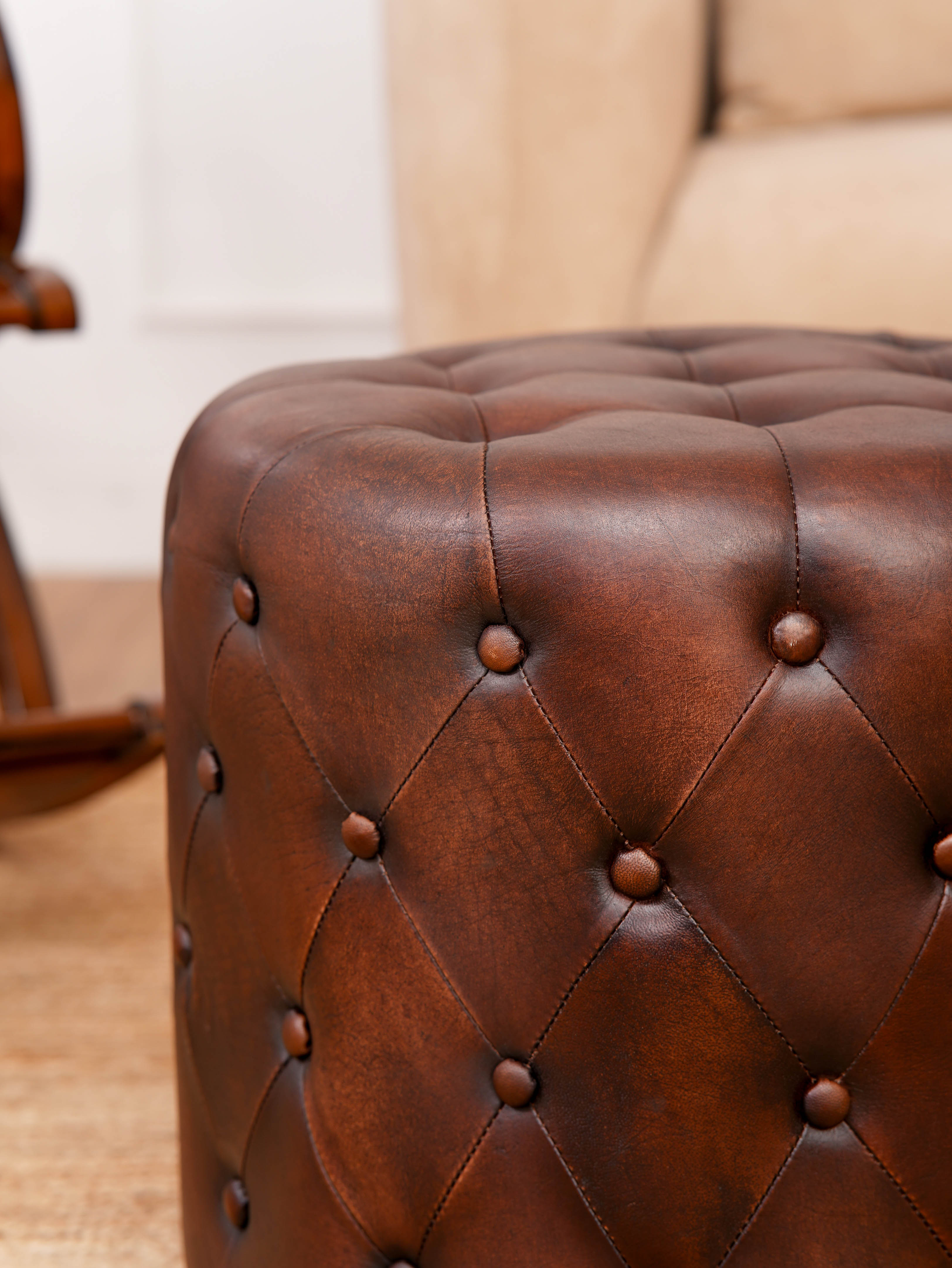 The Regal Repose – Round Tufted Leather Ottoman with Solid Wood Frame