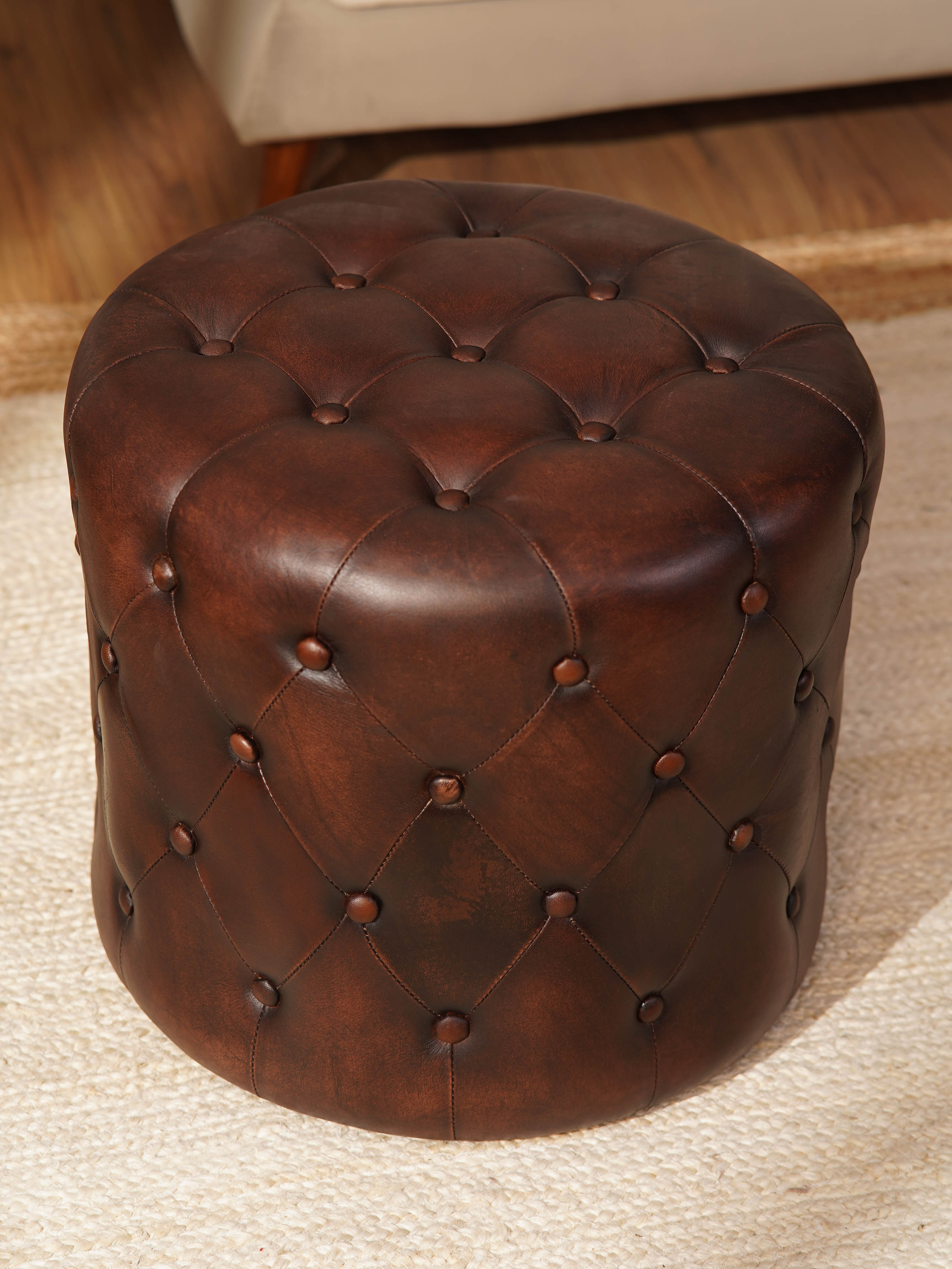 The Regal Repose – Round Tufted Leather Ottoman with Solid Wood Frame