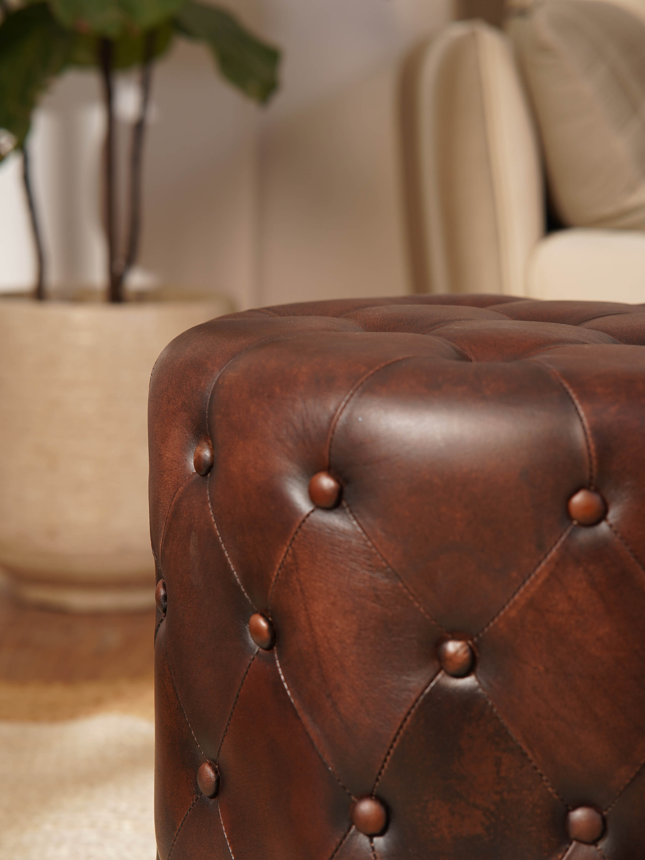 The Regal Repose – Round Tufted Leather Ottoman with Solid Wood Frame
