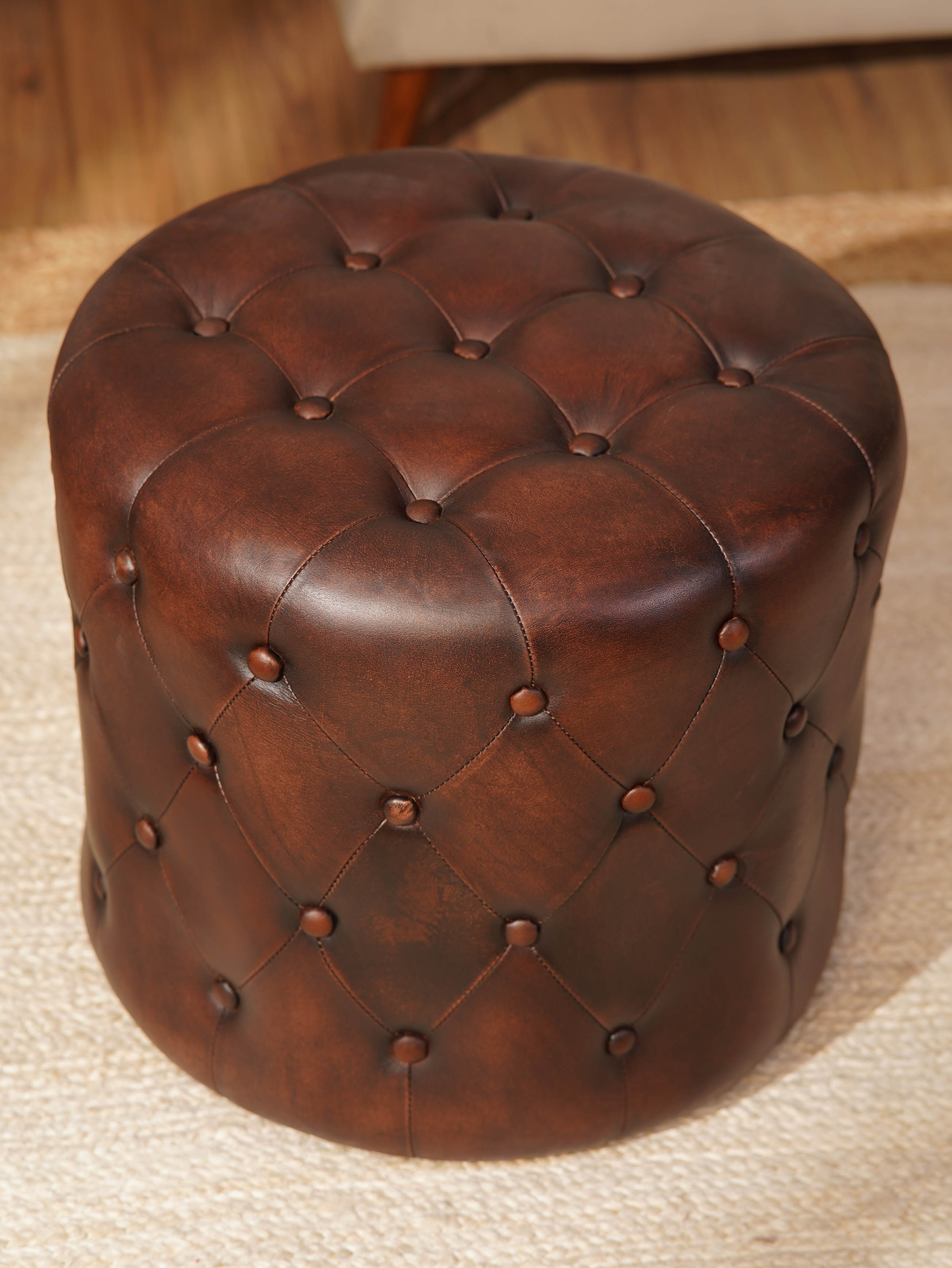 The Regal Repose – Round Tufted Leather Ottoman with Solid Wood Frame