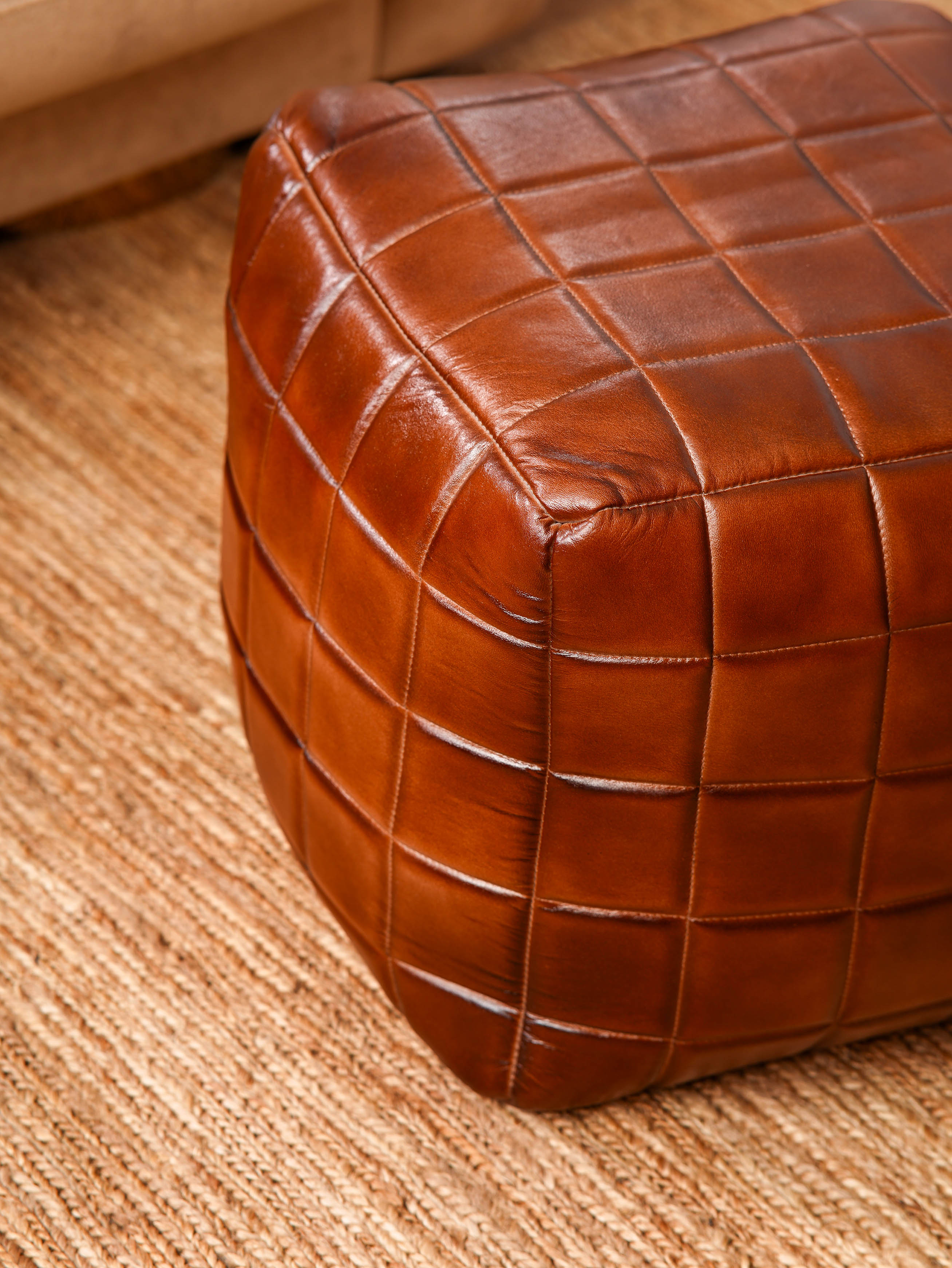 Top-down view of Metro Grid Leather Pouf showing square shape and stitched leather texture

