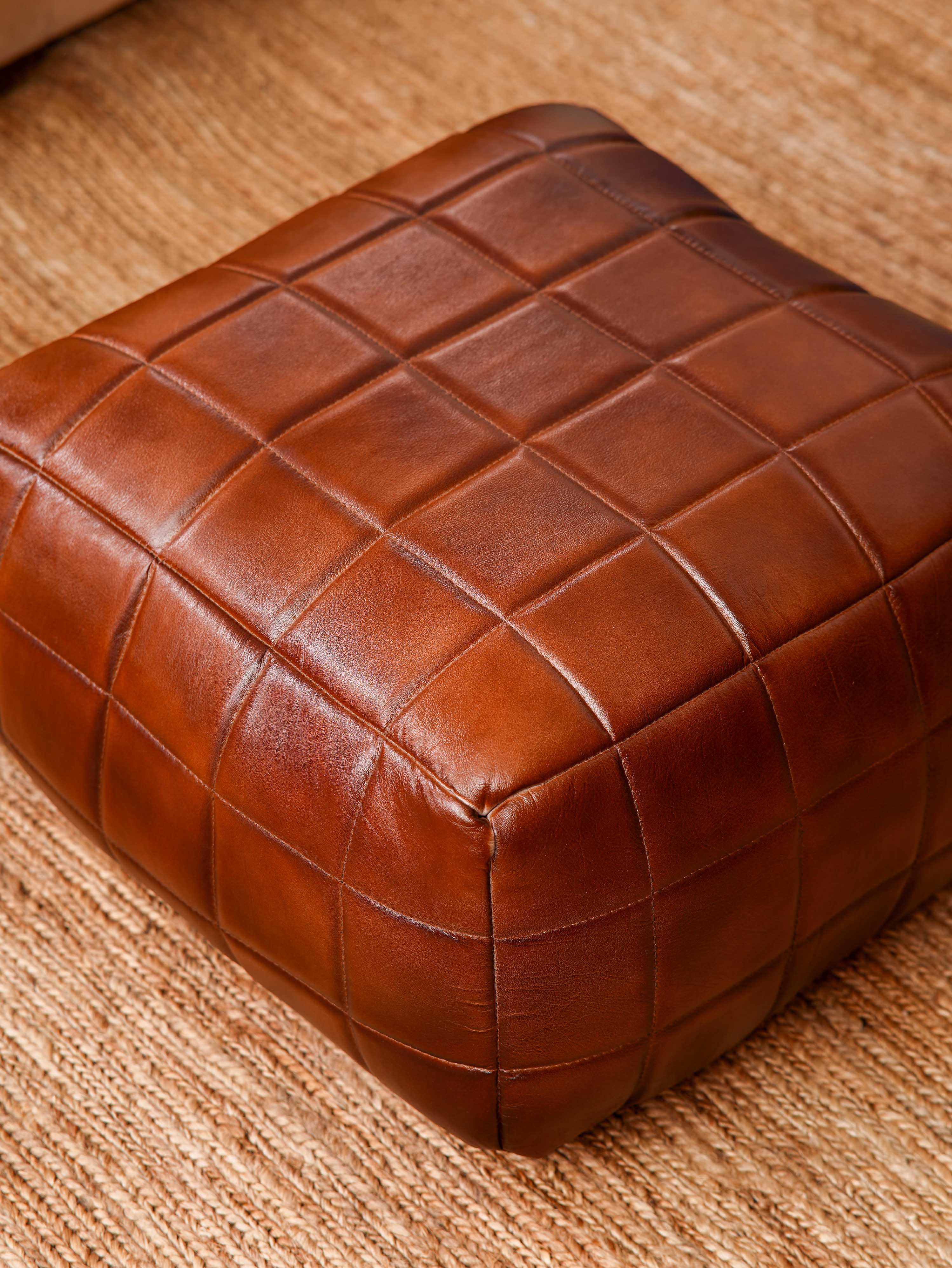 Top-down view of Metro Grid Leather Pouf showing square shape and stitched leather texture

