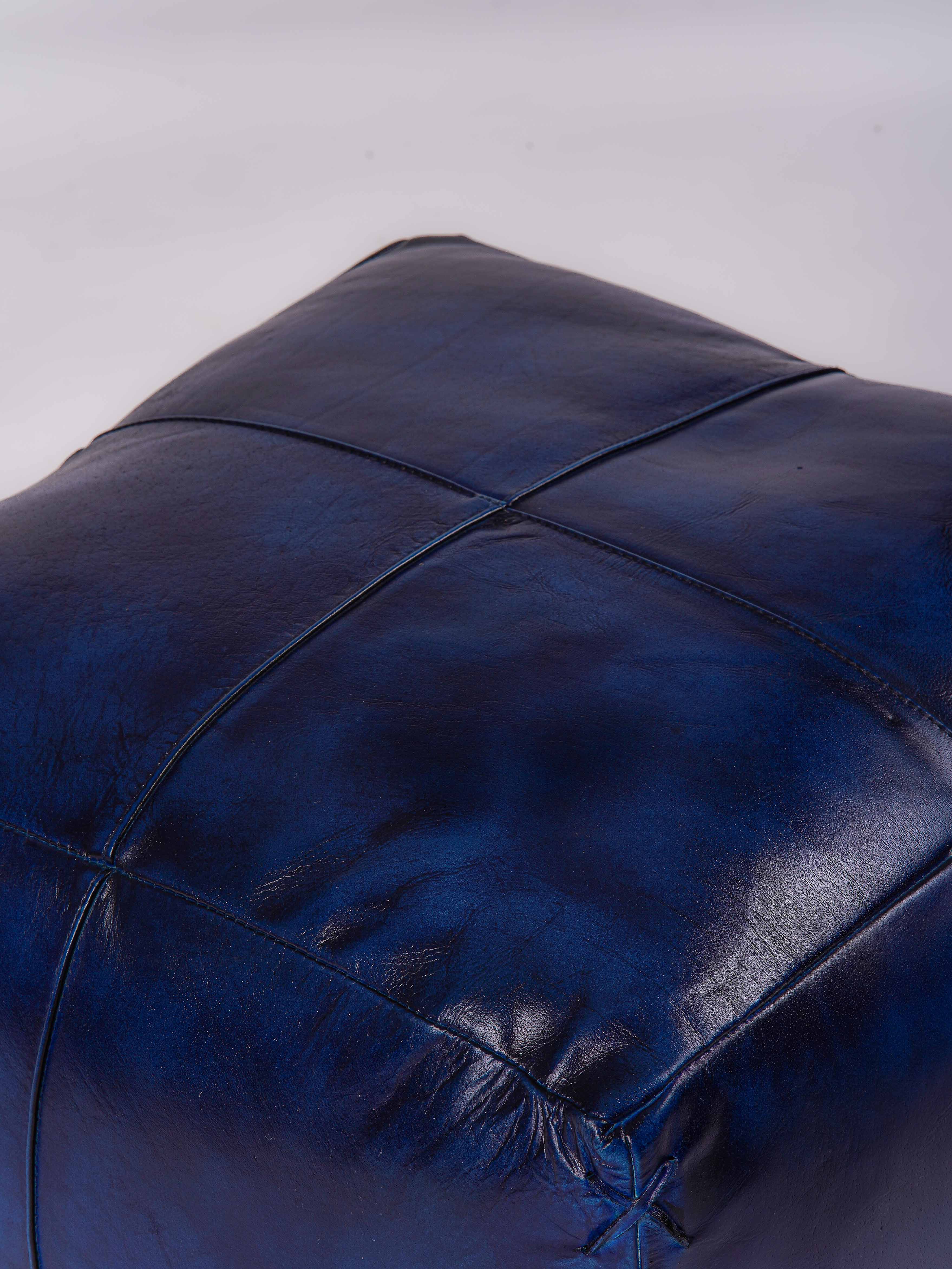 Top-down view of handmade blue leather pouf
